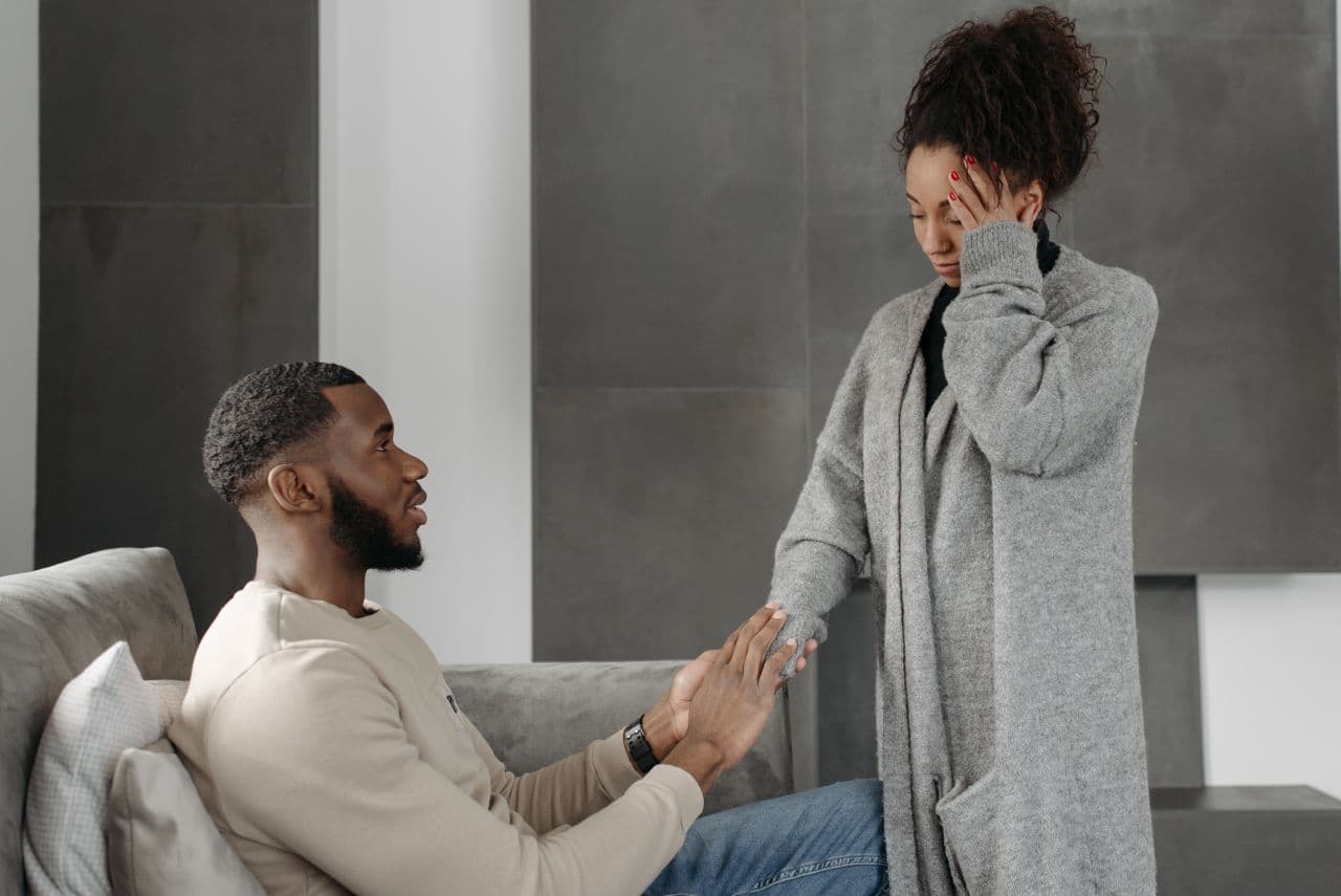 man-sitting-on-a-chair-holding-woman-s-hand
